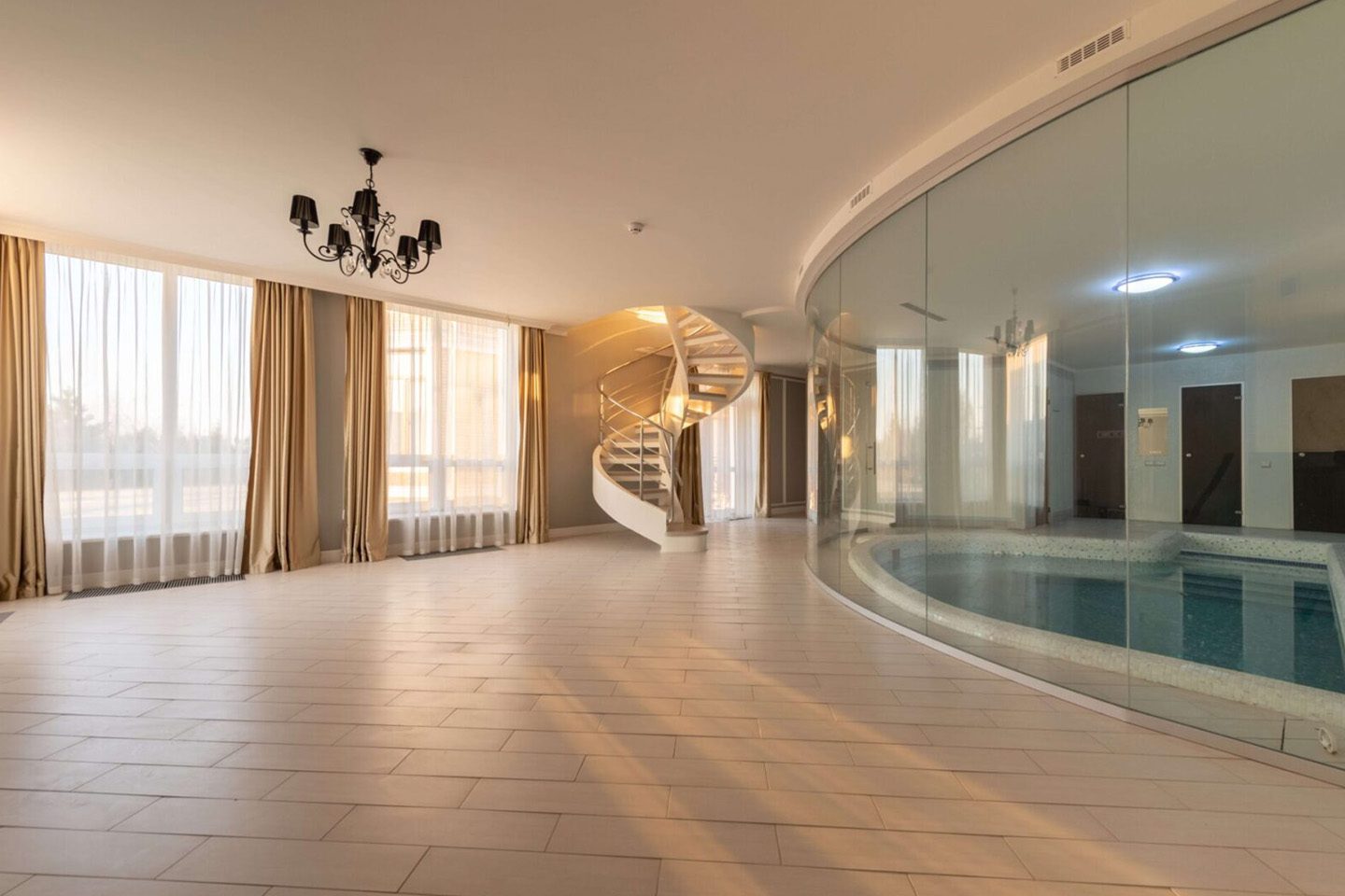 A large room with a pool and stairs.