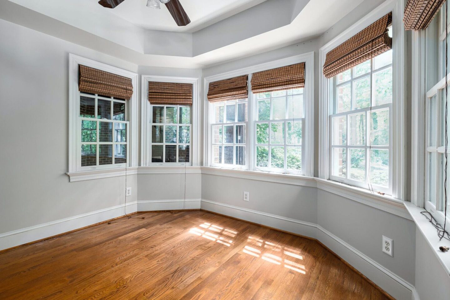 A room with many windows and wooden floors