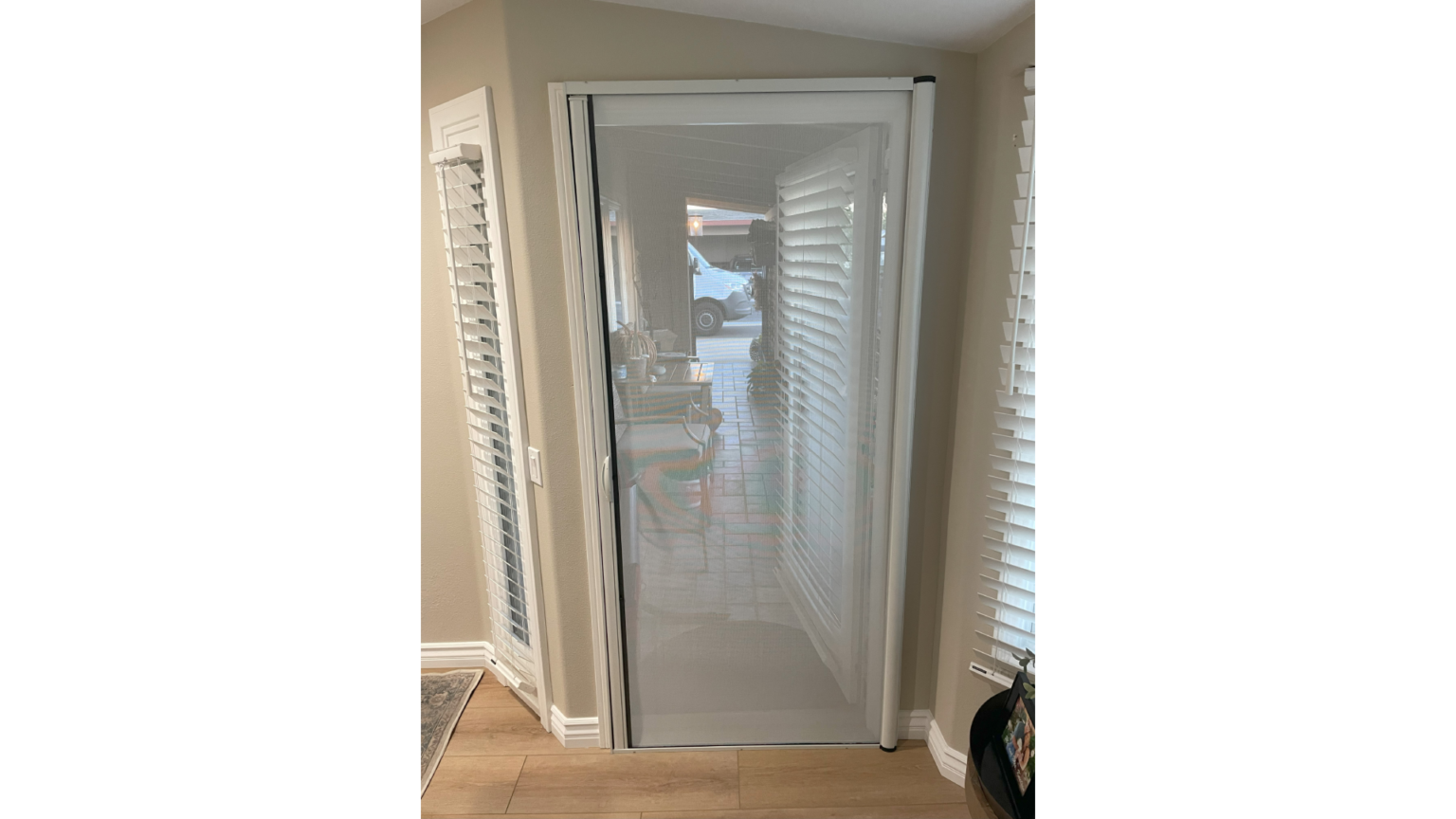 A door that is open and has shutters on the side.
